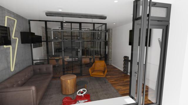 Rincón lounge industrial con toques lúdicos